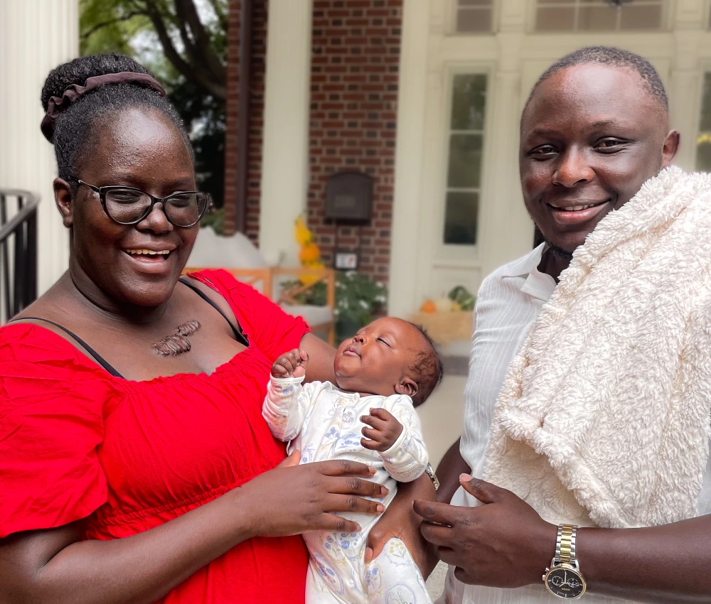 mother and father holding tiny newborn baby