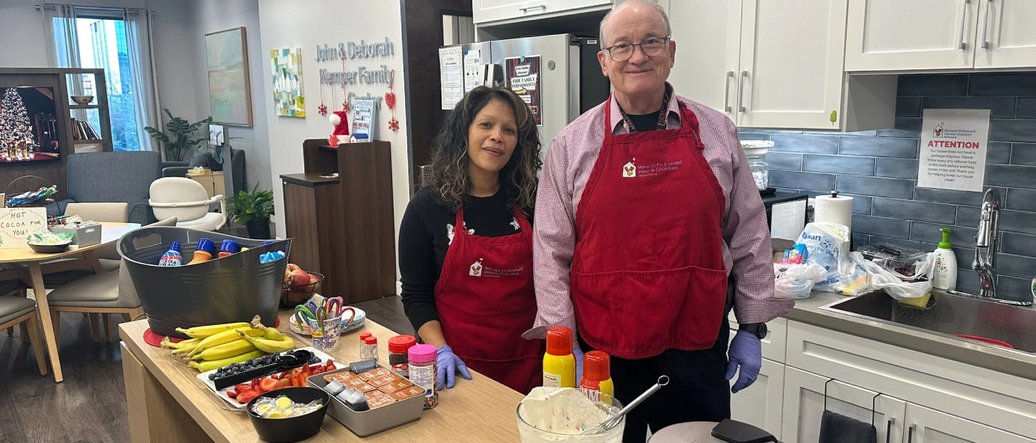 two volunteers preparing breakfast for our families