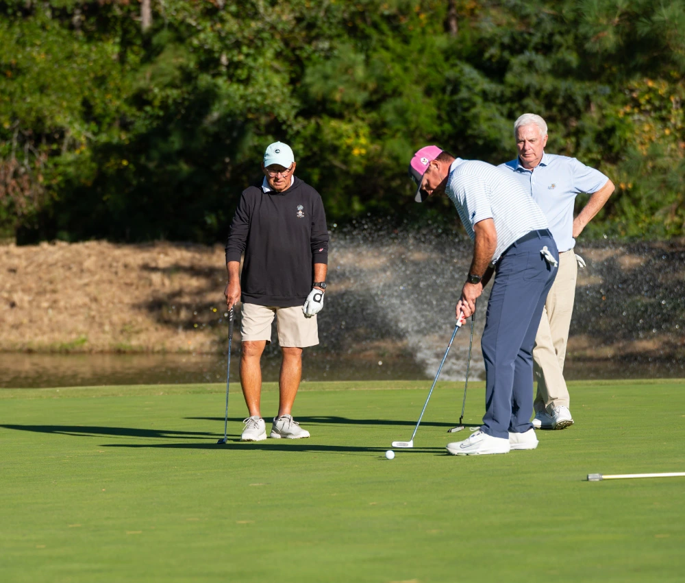 golf team on the green putting